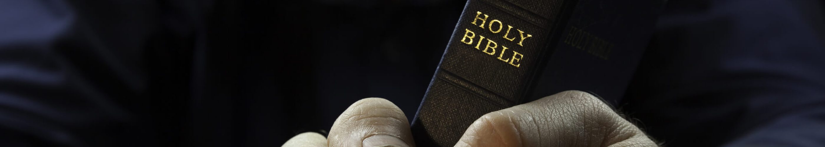 A Man Holding A Holy Bible.